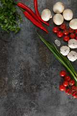 Fresh juicy vegetables with copy space on black background, top view.