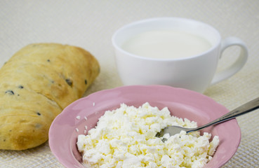 A set of dairy products and bread on a light background.