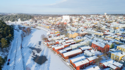Aerial beautiful view of wooden red house and Porvoo old town near the river. Finland.