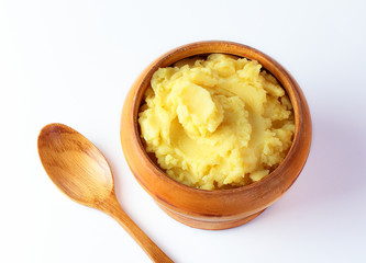 mashed potatoes in wooden bowl on table with spices