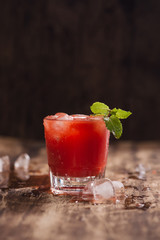 Refreshing summer watermelon juice in glasses on wooden table.
