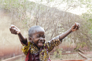 Water is coming! African ethnicity little boy happy to finally get some rain © Riccardo Niels Mayer