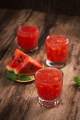 Refreshing summer watermelon juice in glasses with slices of watermelon