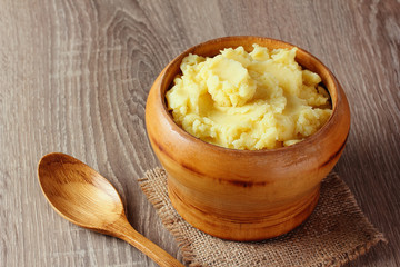 mashed potatoes in wooden bowl on table with spices