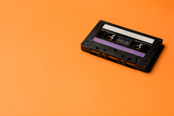 Obraz premium Retro cassette tape over orange background. top view. copy space