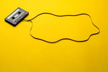 Retro cassette tape over yellow background. top view. copy space