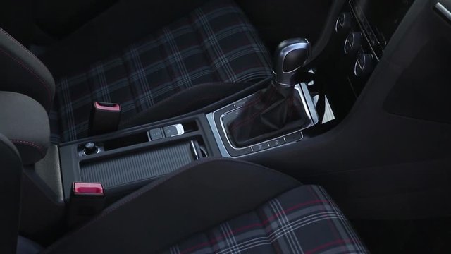 Gearshift, dashboard and seats with armrests in interior new luxury car close up