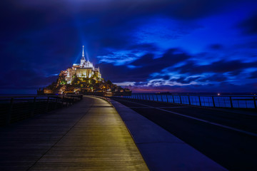 Mont Saint Michael with light on pathway  during night time, BRITTANY, FRANCE