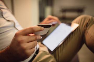 Close-up of man hands holding credit card.