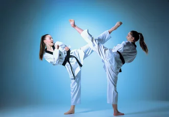 Zelfklevend Fotobehang The studio shot of group of kids training karate martial arts © master1305