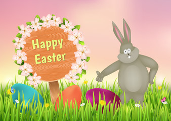 Easter bunny and eggs on the meadow.