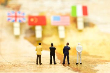 Miniature people : Businessman stand on map and look for country of business. Image use business concept.