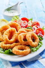 Crispy golden deep fried squid rings in batter