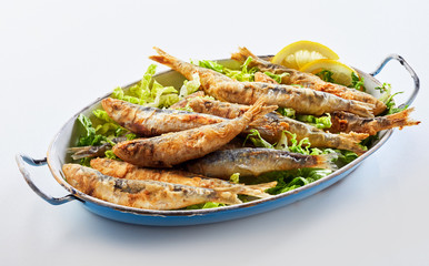 Old vintage dish with fried sardines in batter