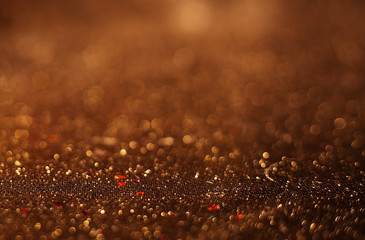 Gold Festive Christmas background. Elegant abstract background with bokeh defocused lights and stars.