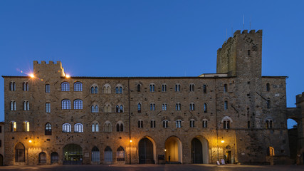 Pretorio Palace and Porcellino Tower, Priori Square in a quiet moment of the evening with the blue light, Volterra, Pisa, Tuscany, Italy