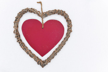 wooden heart with ribbon on a snow, holiday background