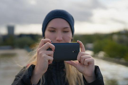 Teen Girl Taking Photos With Smartphone In The City