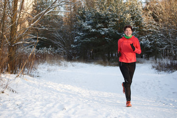 Photo of happy sports girl on morning run in winter park