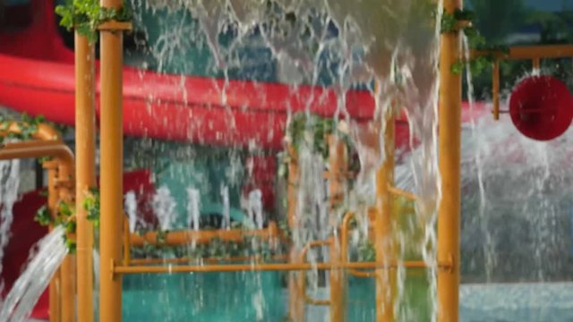children amusement water park. Streams of water flowing from cascade waterfall