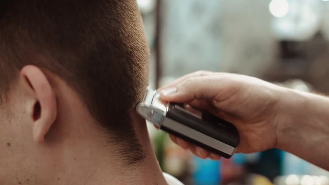 Triangle trimmer in barber shop. Men's haircut and body care.