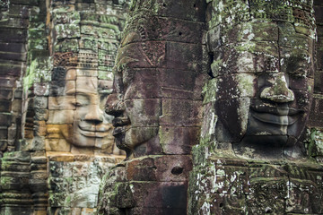 Fototapeta na wymiar Bayon Temple Angkor Thom, The serenity of the stone faces Cambodia. Huge sculptures of faces in the archaeological site of Angkor Thom. Face-towers depicting Bodhisattva Avalokiteshvara