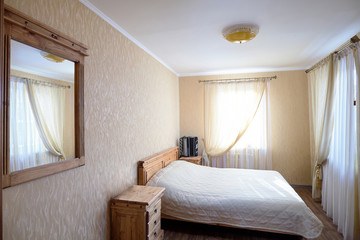 Interior of Bedroom of Rural House with Bayan on Nightstand