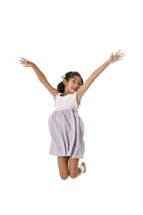 Girl jumping on white background.