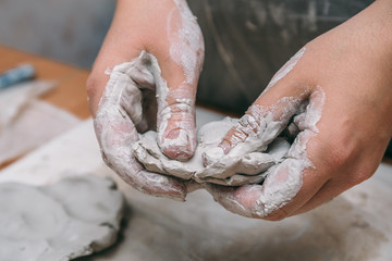 Female potter works with clay, craftsman hands close up