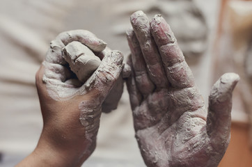 Female potter works with clay, craftsman hands close up