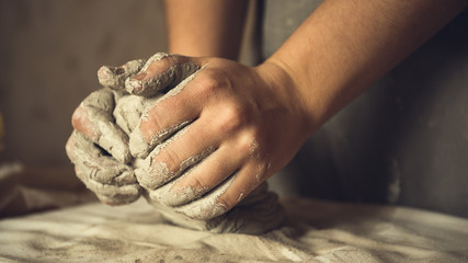 Female potter works with clay, craftsman hands close up