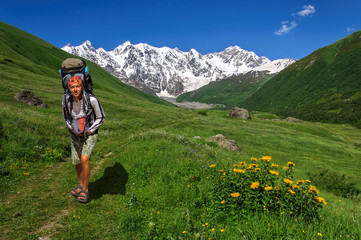 Fototapeta na wymiar tourist with a big backpack is traveling in the Caucasus mountains, Georgia.