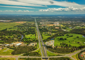Aerial view of Caboolture and Bruce highway to Brisbane with Bribie Island Road crossing