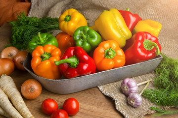 Red, green and yellow sweet bell peppers on table,