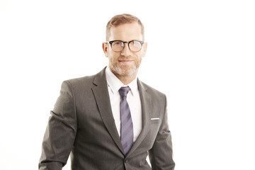 Smiling businessman portrait. Successful senior manager business man wearing suit while standing against at isolated white background. 