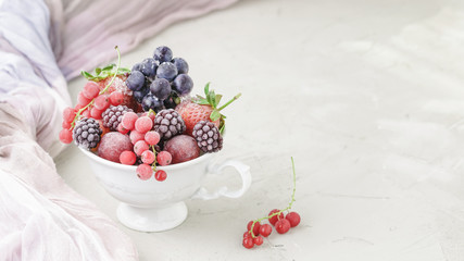 Assortment of frozen berries in white cup