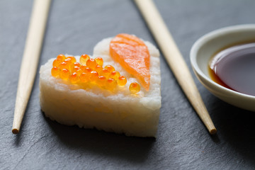 Sushi heart macro seafood concept with salmon and caviar

