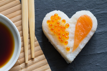 Sushi heart macro seafood concept with salmon and caviar
