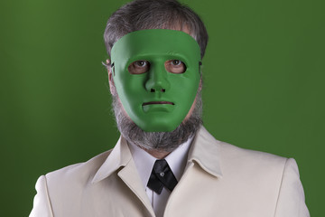 a man in a green mask