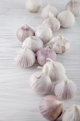 Fresh garlic decorated on a white wooden kitchen plate can be used as background
