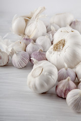 Fresh garlic decorated on a white wooden kitchen plate can be used as background