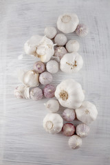 Fresh garlic decorated on a white wooden kitchen plate can be used as background