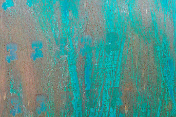Textured metal surface carelessly colored blue paint and faded in the sun in pale gray with rusty specks.