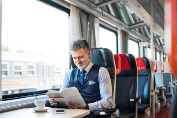 Mature businessman travelling by train.