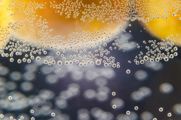 A close-up shot of citrus in a glass of water with lots of bubbles beautiful background for greeting cards and advertising materials.