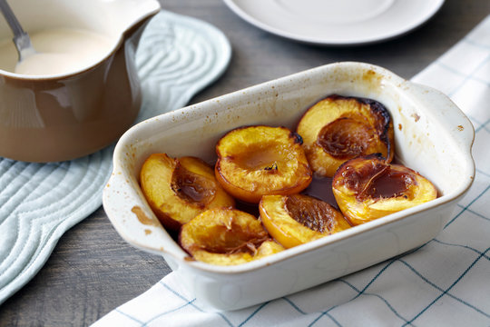 Baked nectarines in white dish, close-up