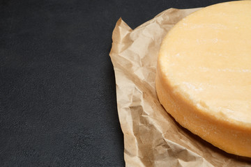 Whole round Head of parmesan or parmigiano hard cheese on concrete background