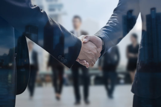 Negotiating business concept, two businessman shaking hand after successful connection and deal about investment and team corporate, finance graph and up arrow.