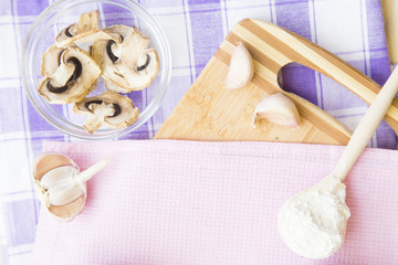 Set of raw ingredients for Italian pasta on a white background. Flour, garlic, mashrooms. Set of healthy food products. Closeup and top view