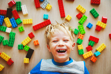 cute little boy love playing with plastic blocks